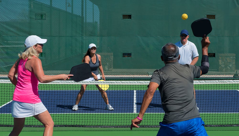 4 people playing a game of Pickleball
